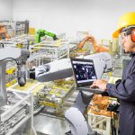 Engineer using laptop computer for maintenance automatic robotic