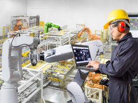 Engineer using laptop computer for maintenance automatic robotic