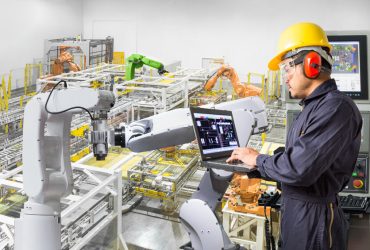 Engineer using laptop computer for maintenance automatic robotic