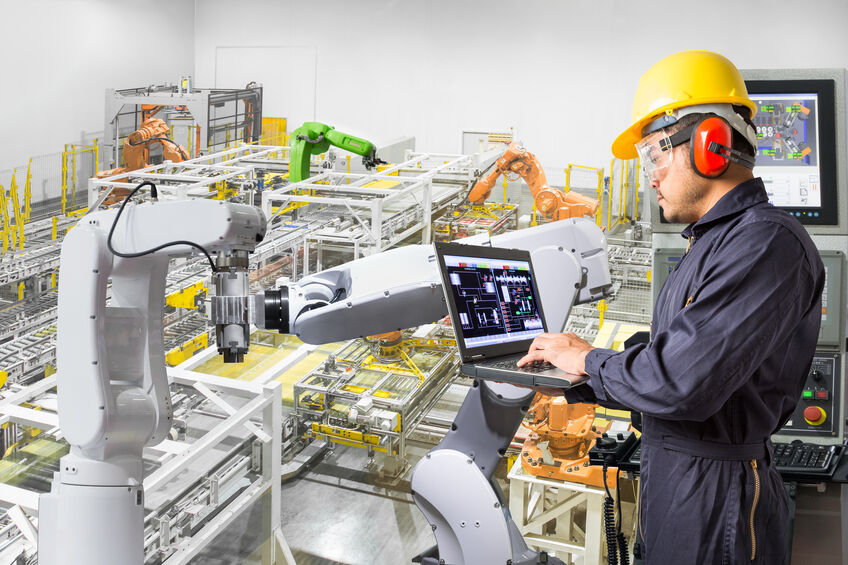 Engineer using laptop computer for maintenance automatic robotic